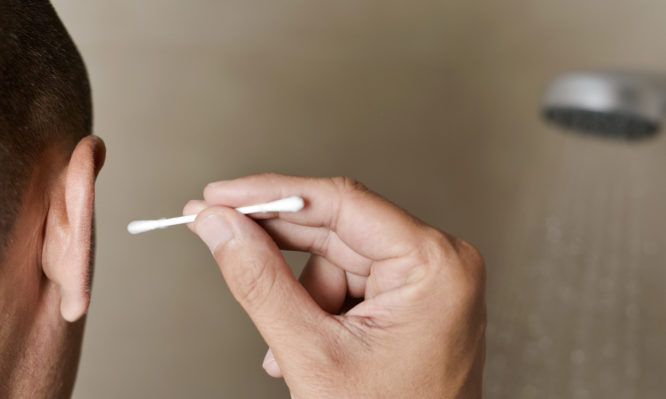 young man about to use a cotton swab